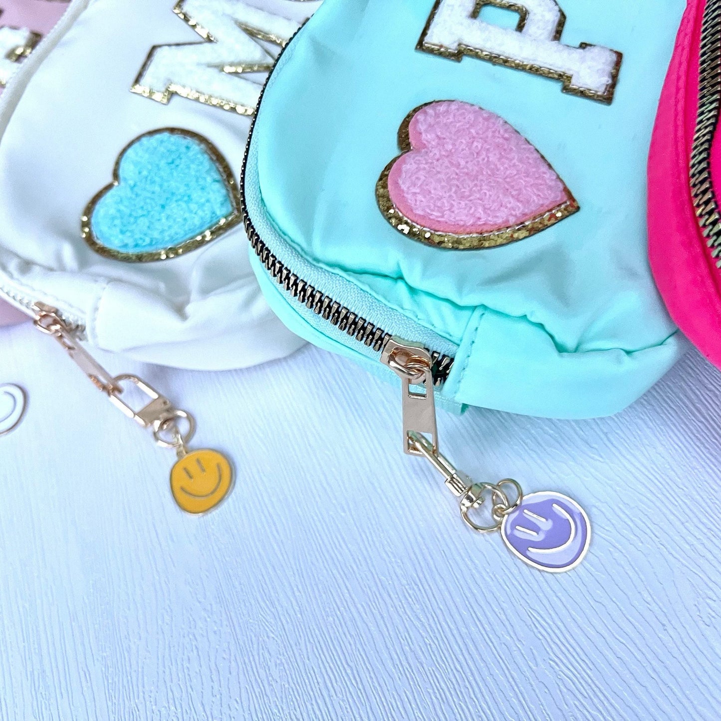 Colorful pouch bags with charms on a light background