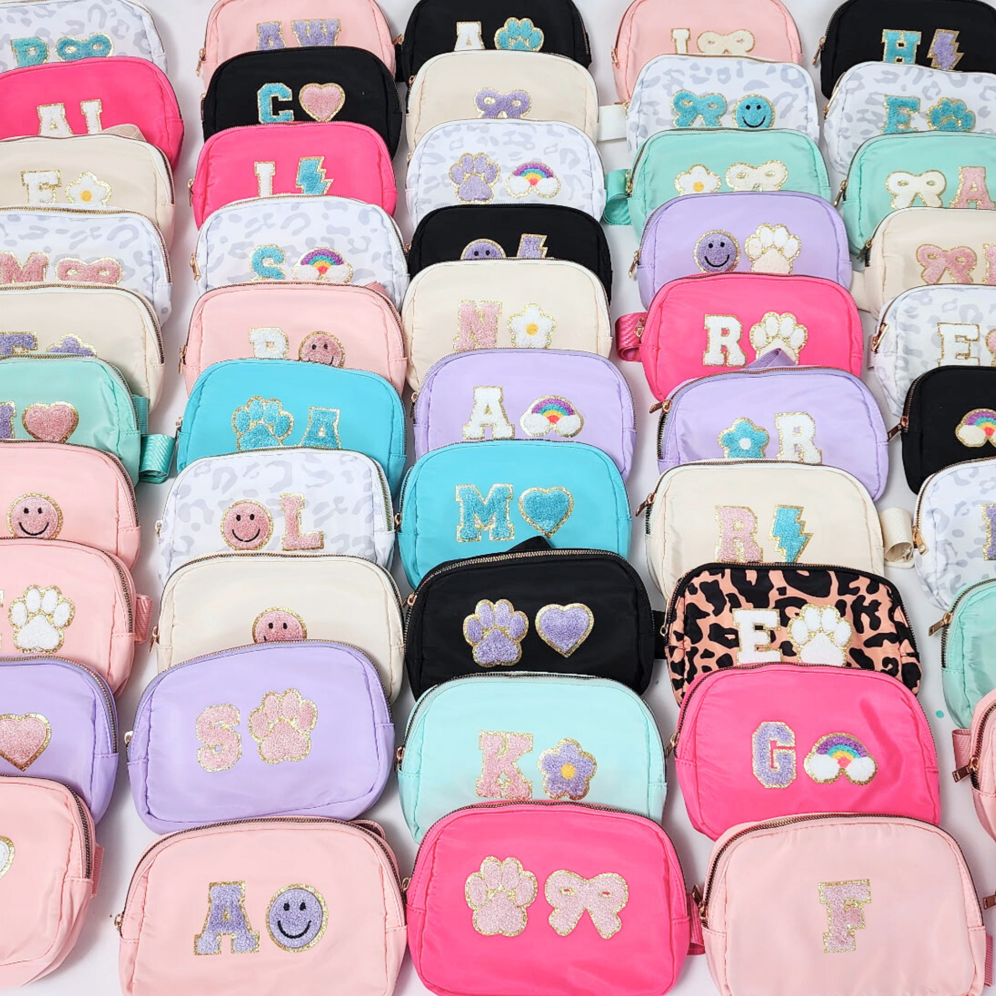 Flat lay of fanny packs in multiple pastel shades