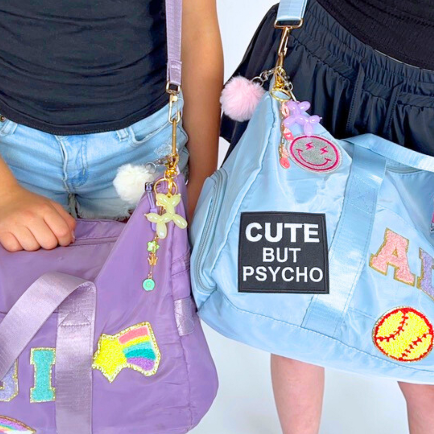 Two people holding colorful bags with decorative elements and text.