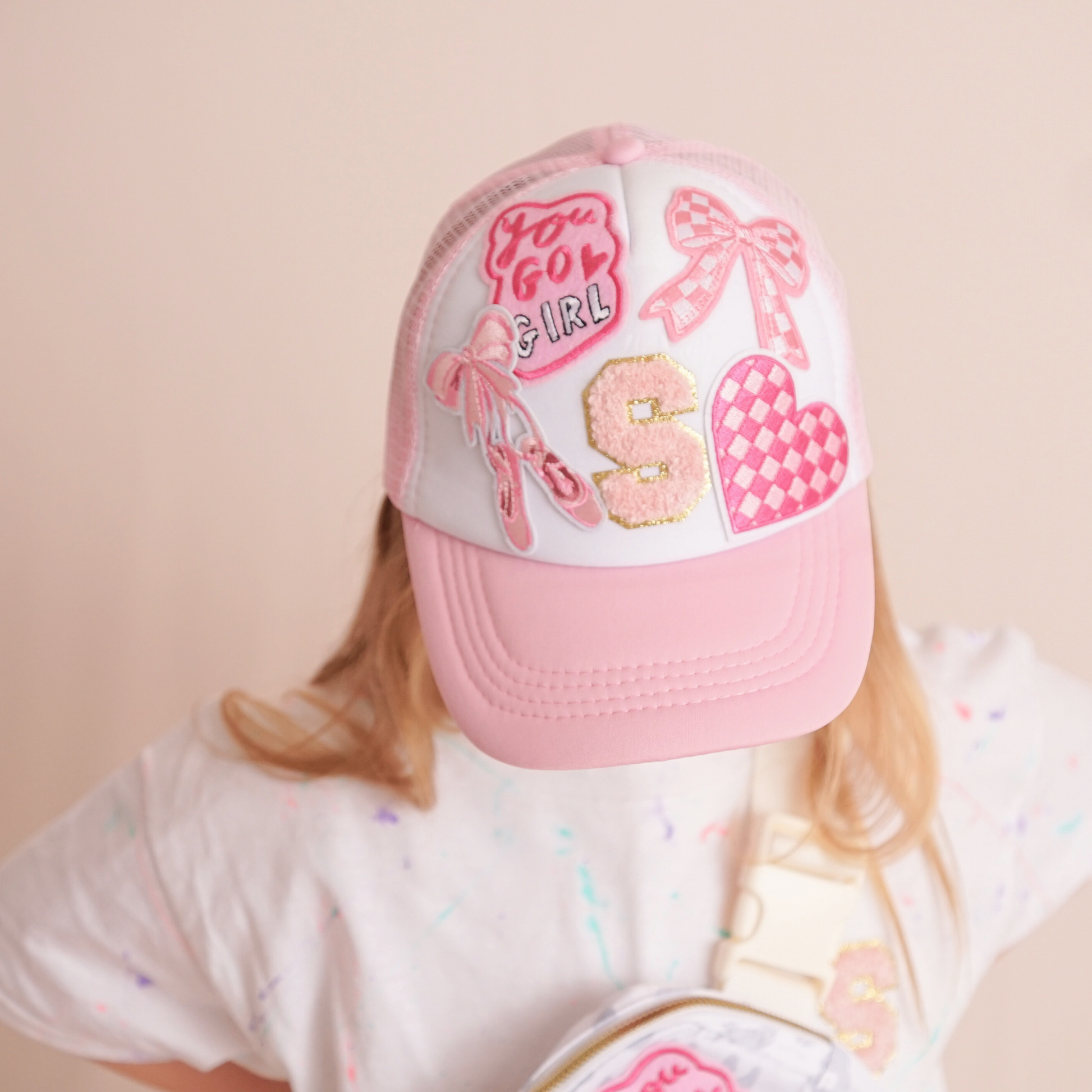 Pink and white cap with decorative elements on a beige background