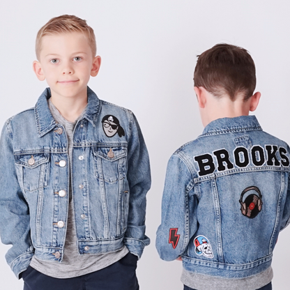 Two children wearing denim jackets with patches, one showing 'Brooks' on the back.