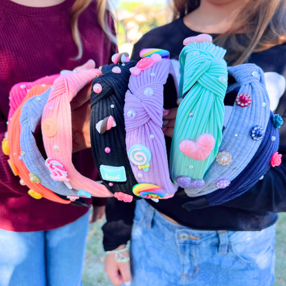 Multiple charm headbands stacked on girls' arms in an outdoor setting