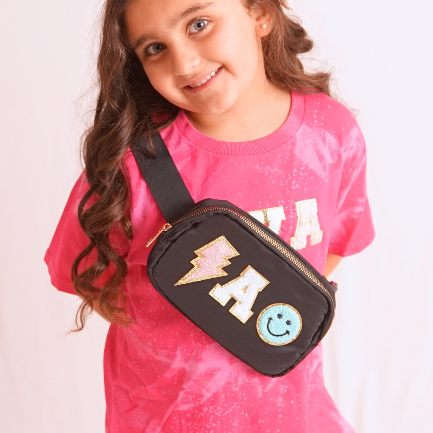 Girl wearing black fanny pack A chenille patches
