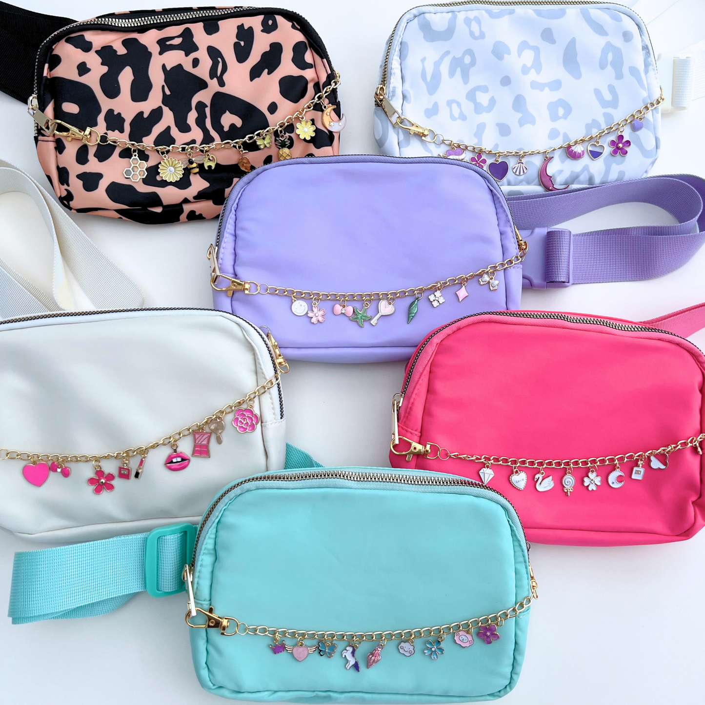 Collection of colorful pouches with decorative chains on a white background