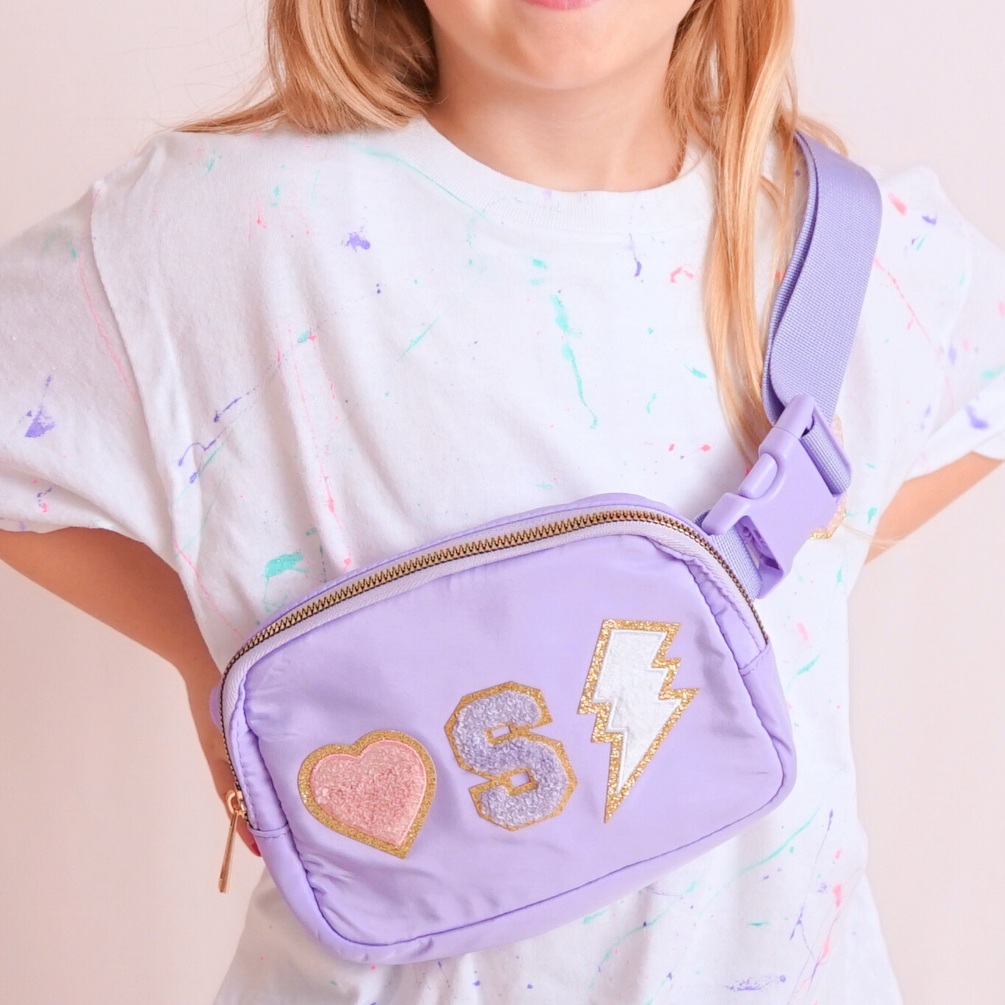 Girl modeling purple fanny pack with an S and chenille patches