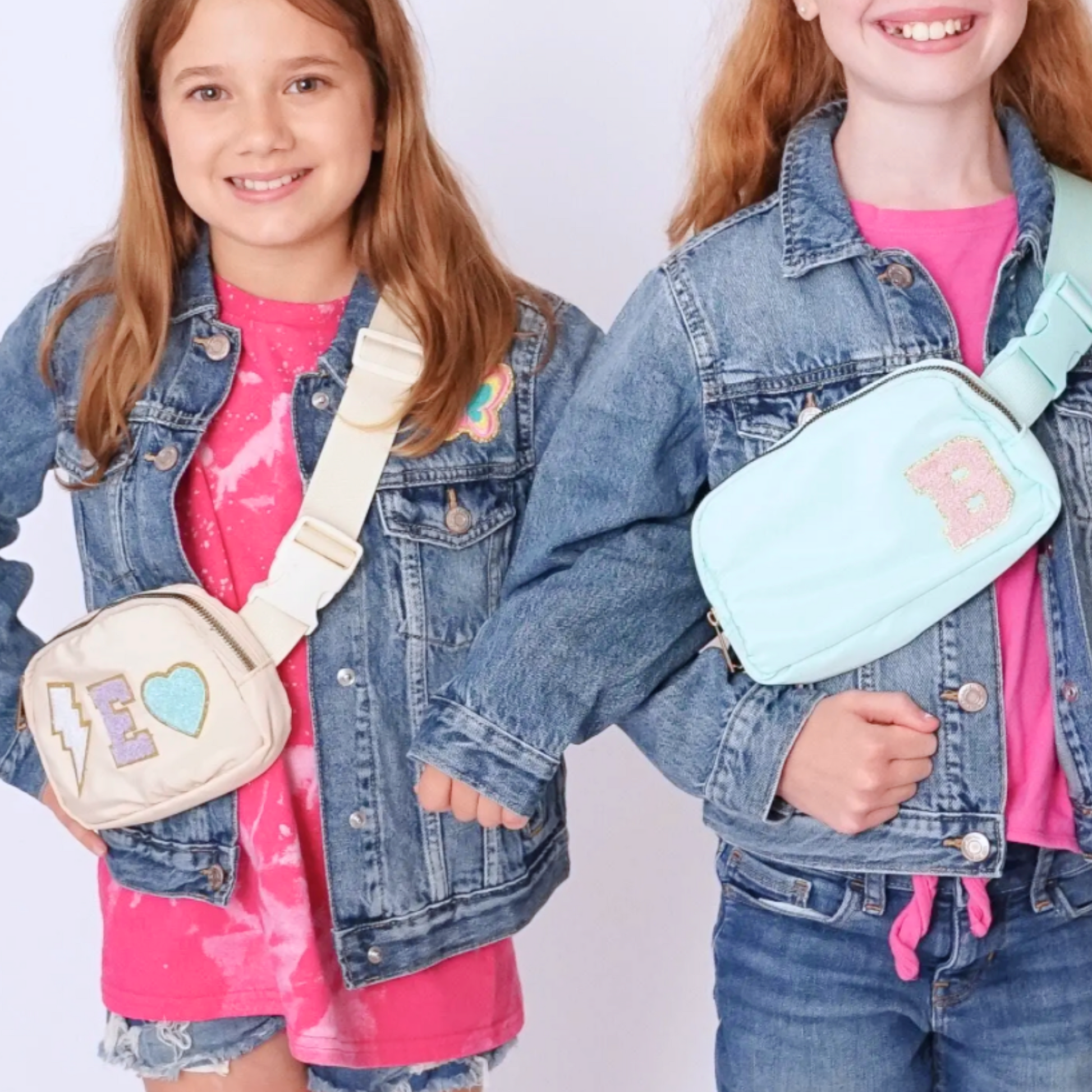 Girls wearing light green and beige fanny packs with initial patches and cute chenille patches