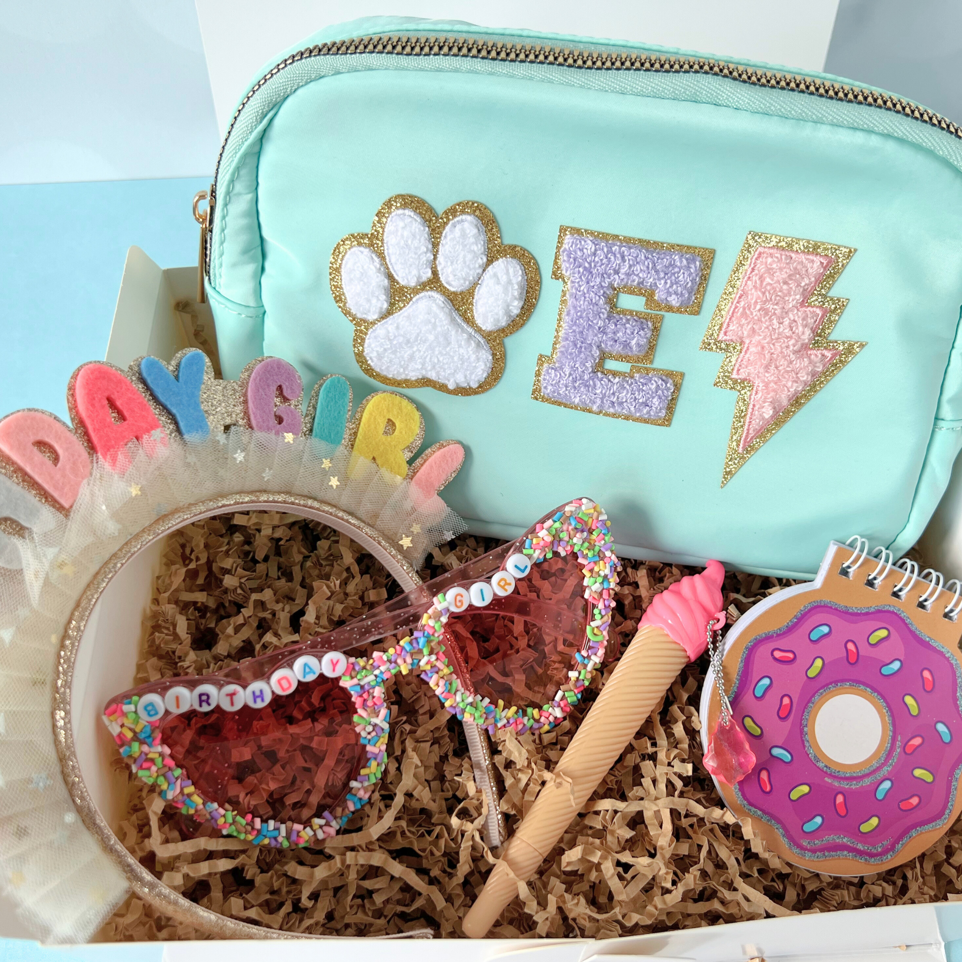 Mint green box set – Mint fanny pack with lightning bolt and paw patch, arranged with birthday accessories in gift box.