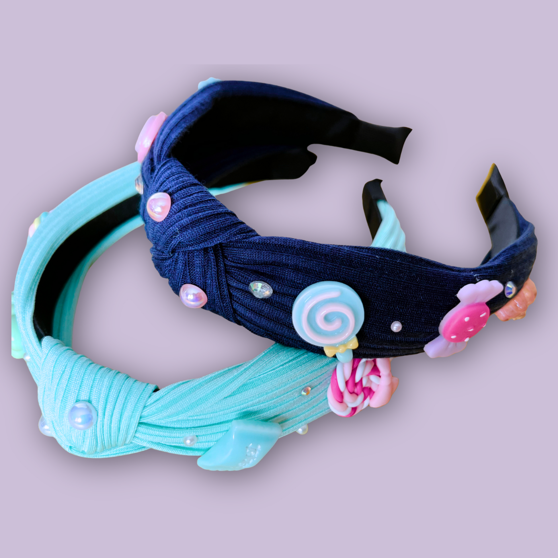 Two charm headbands laid flat showing front and side detail on gray background