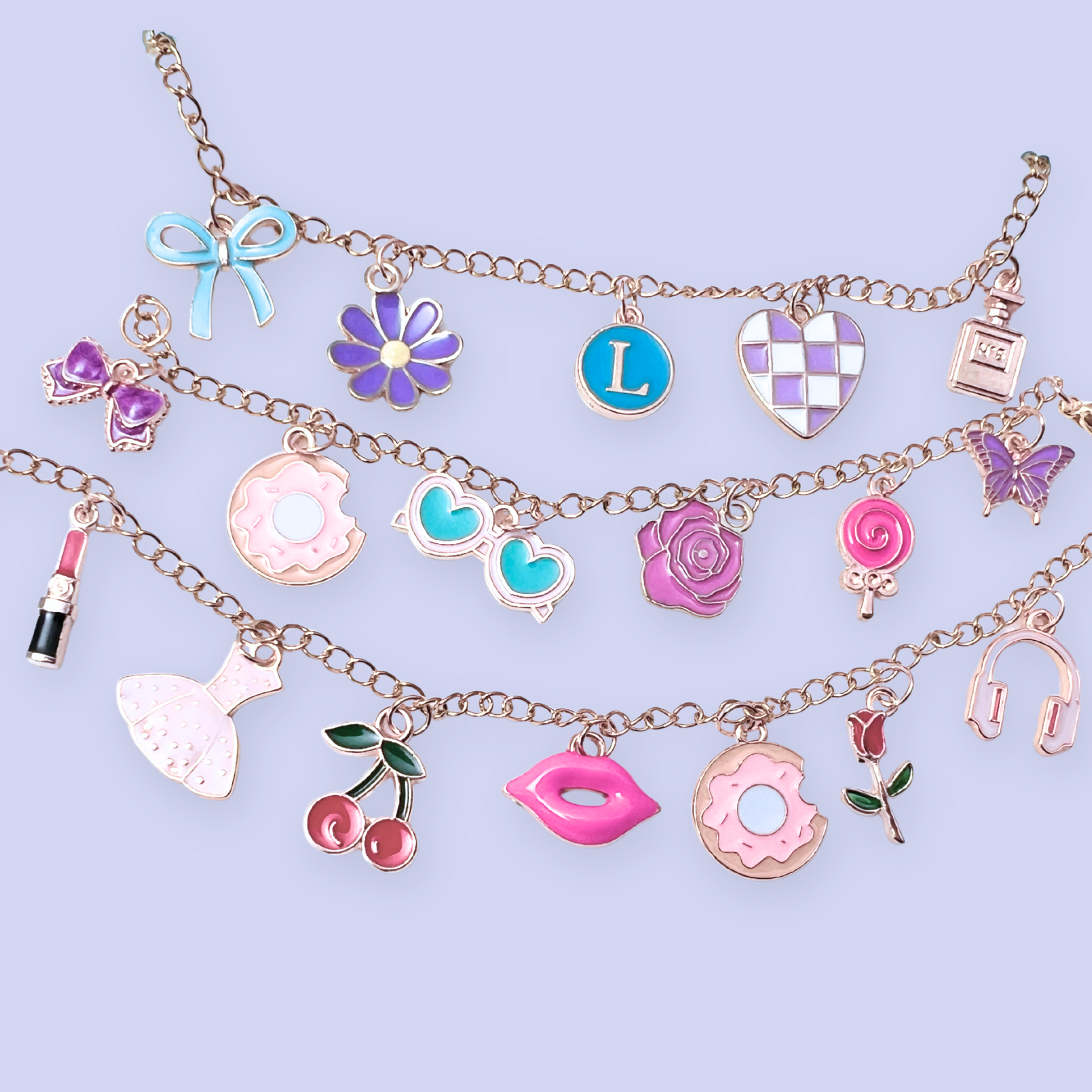 Multiple charm bracelets with various colorful charms on a light purple background