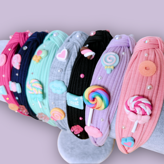 Colorful topknot charm headbands in a row with candy and pearl embellishments