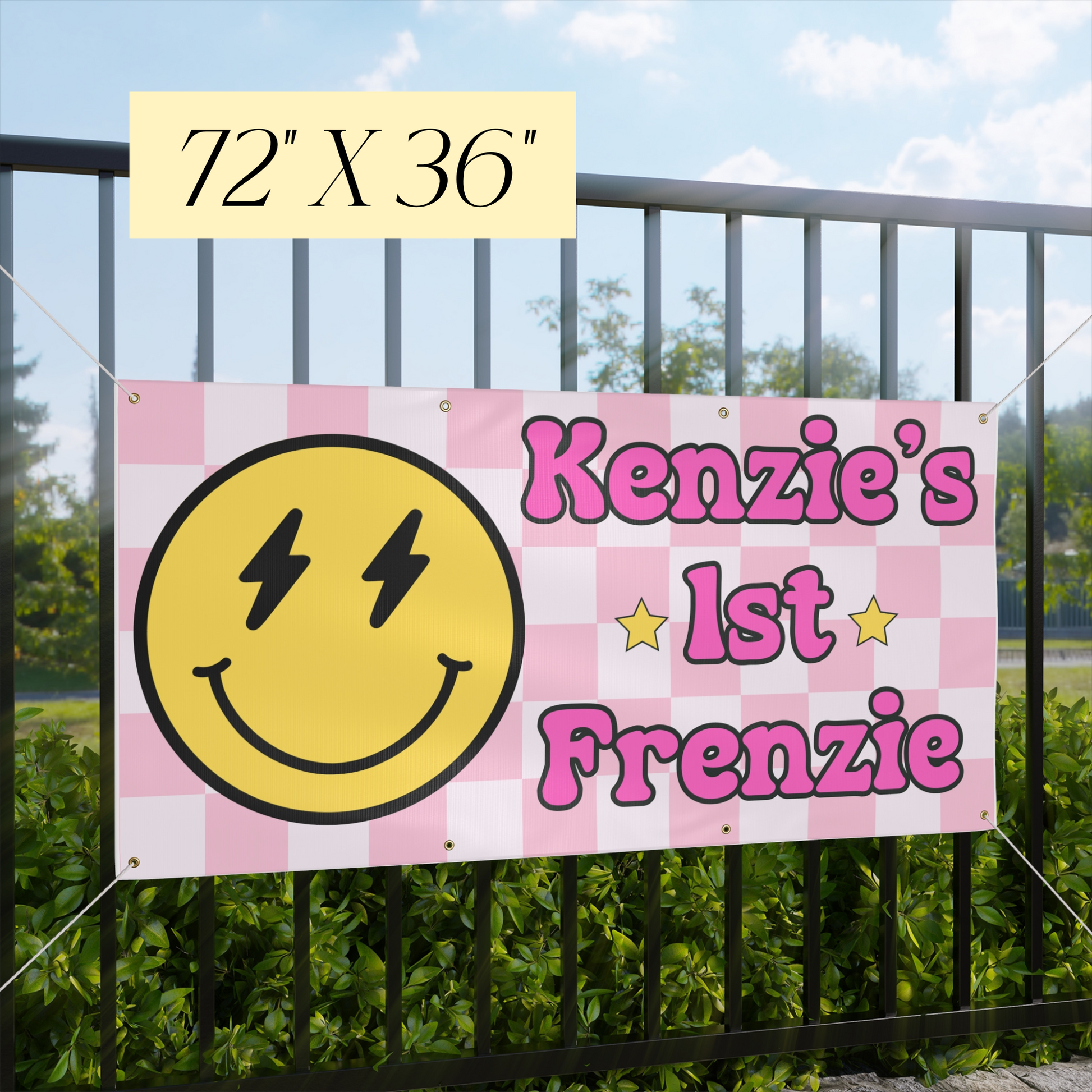 Checkered banner with smiley face and text 'Kenzie's 1st Frenzie' against a fence and greenery background