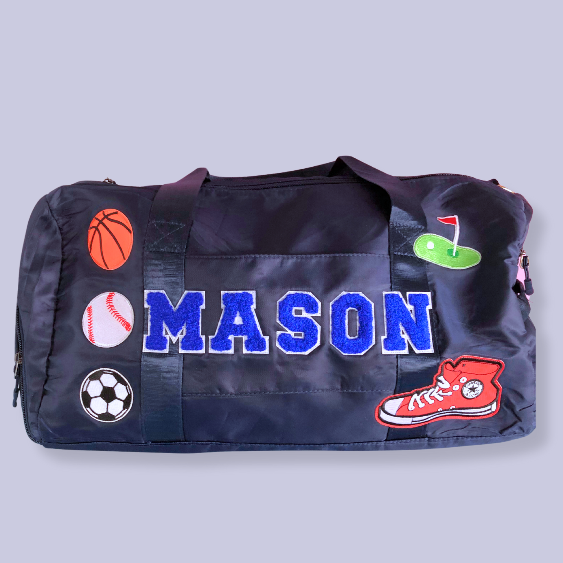 Navy duffle bag with MASON and patches including soccer, basketball, and sneakers.