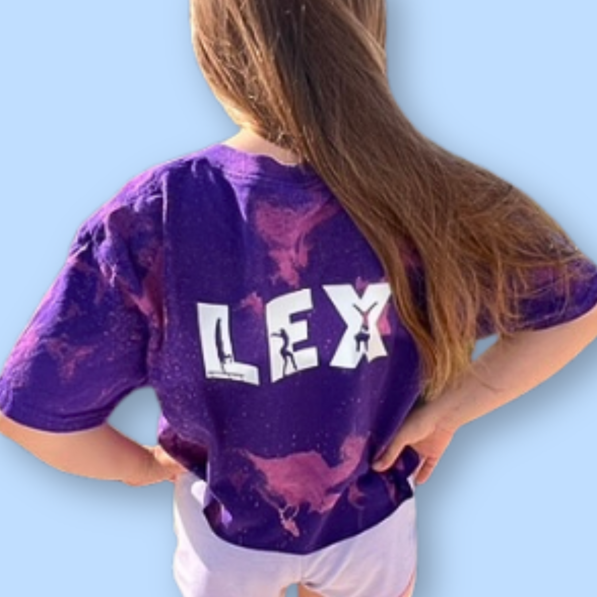 Person wearing a purple tie-dye shirt with 'LEX' printed on the back against a light blue background