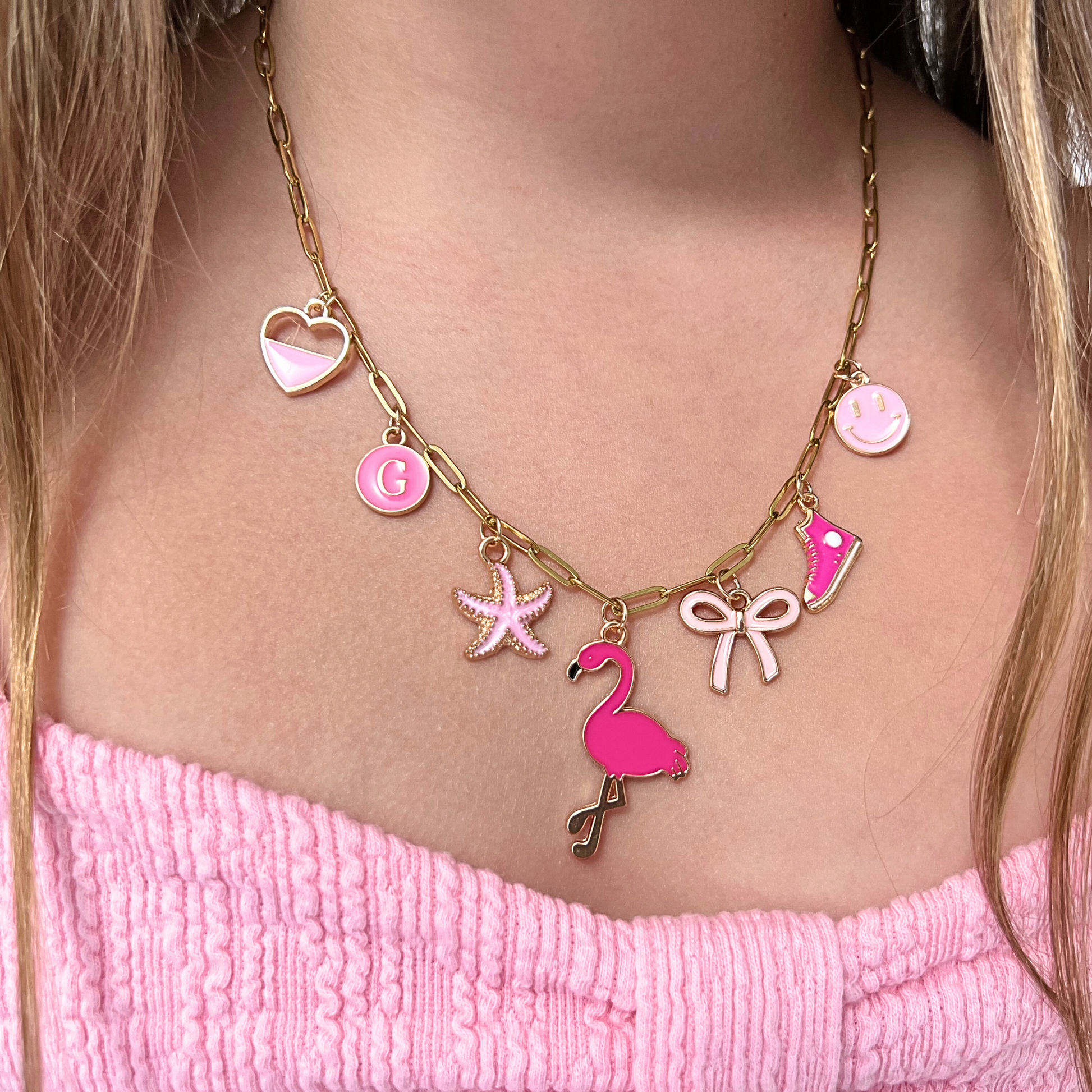 Necklace with pink flamingo charm worn by a young girl