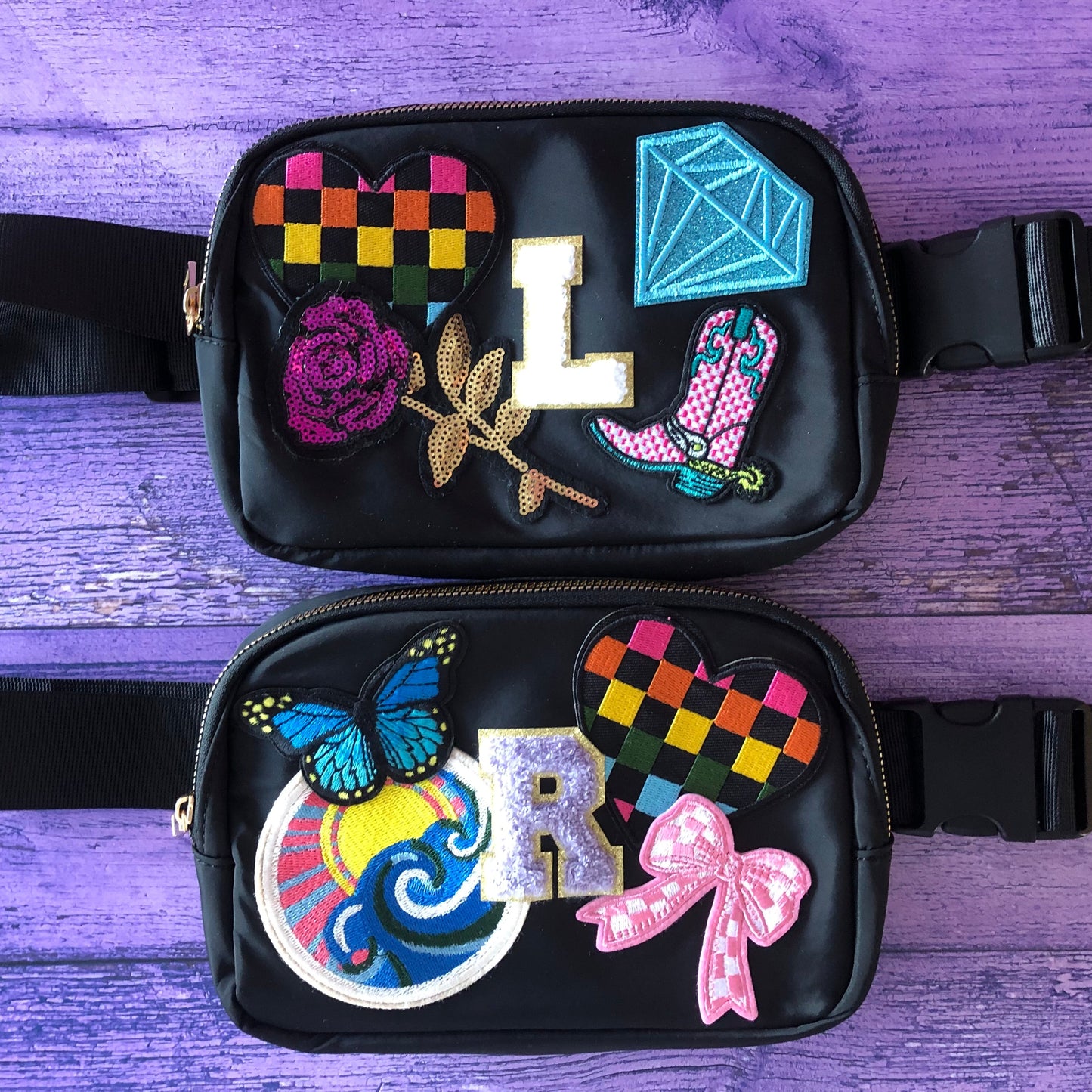 Black waist bag with colorful decorative patches on a purple wooden surface