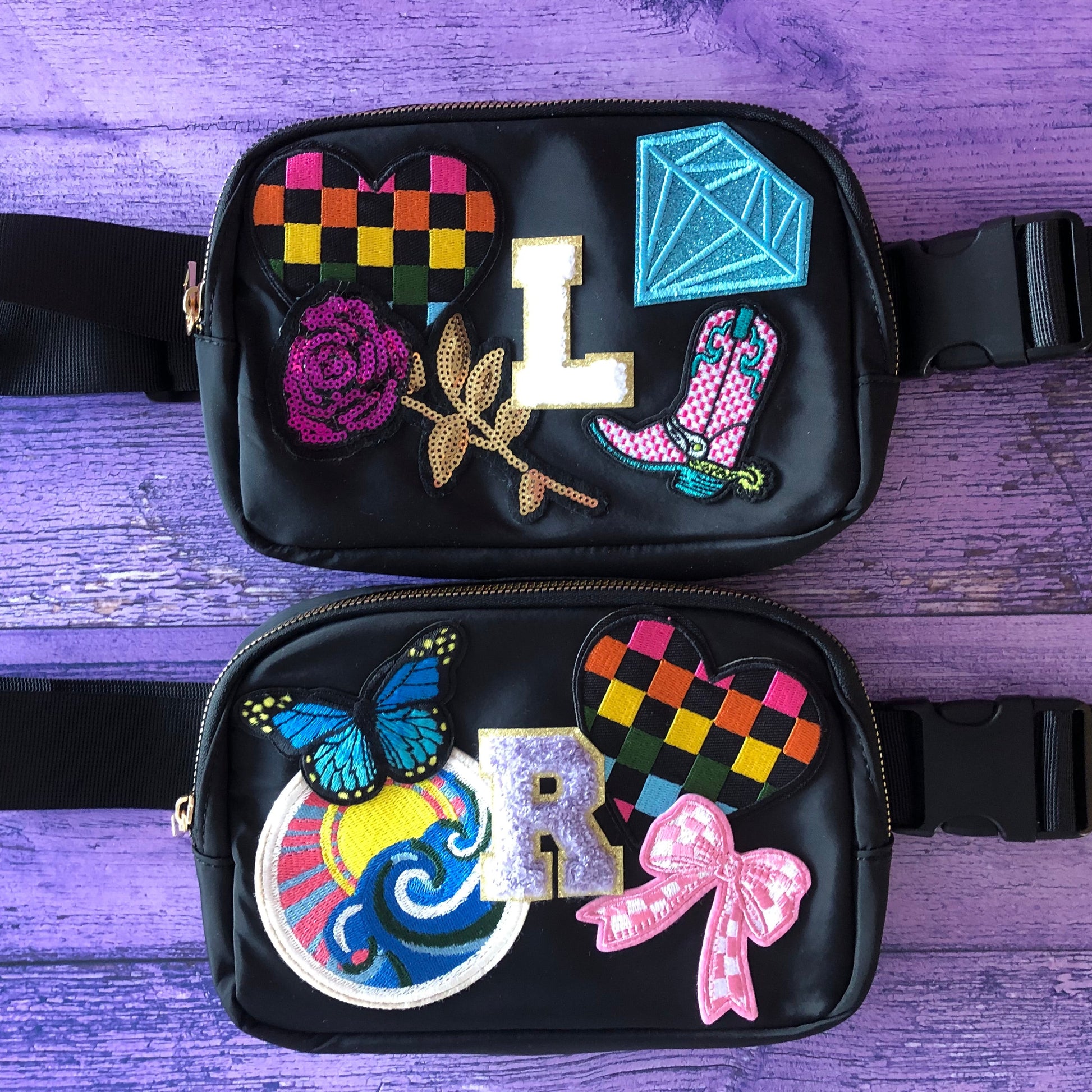 Black waist bag with colorful decorative patches on a purple wooden surface