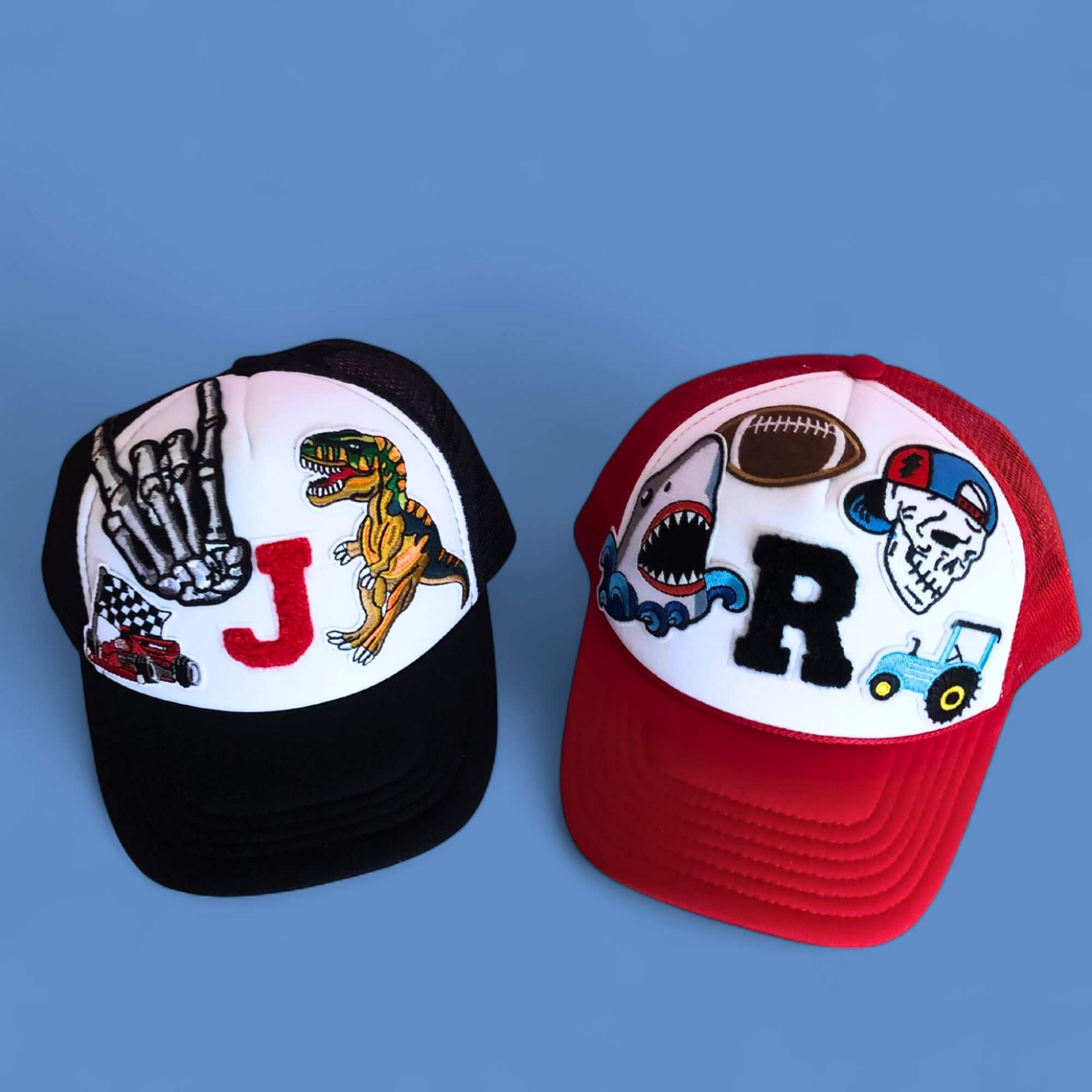 Two baseball caps with colorful designs on a blue background