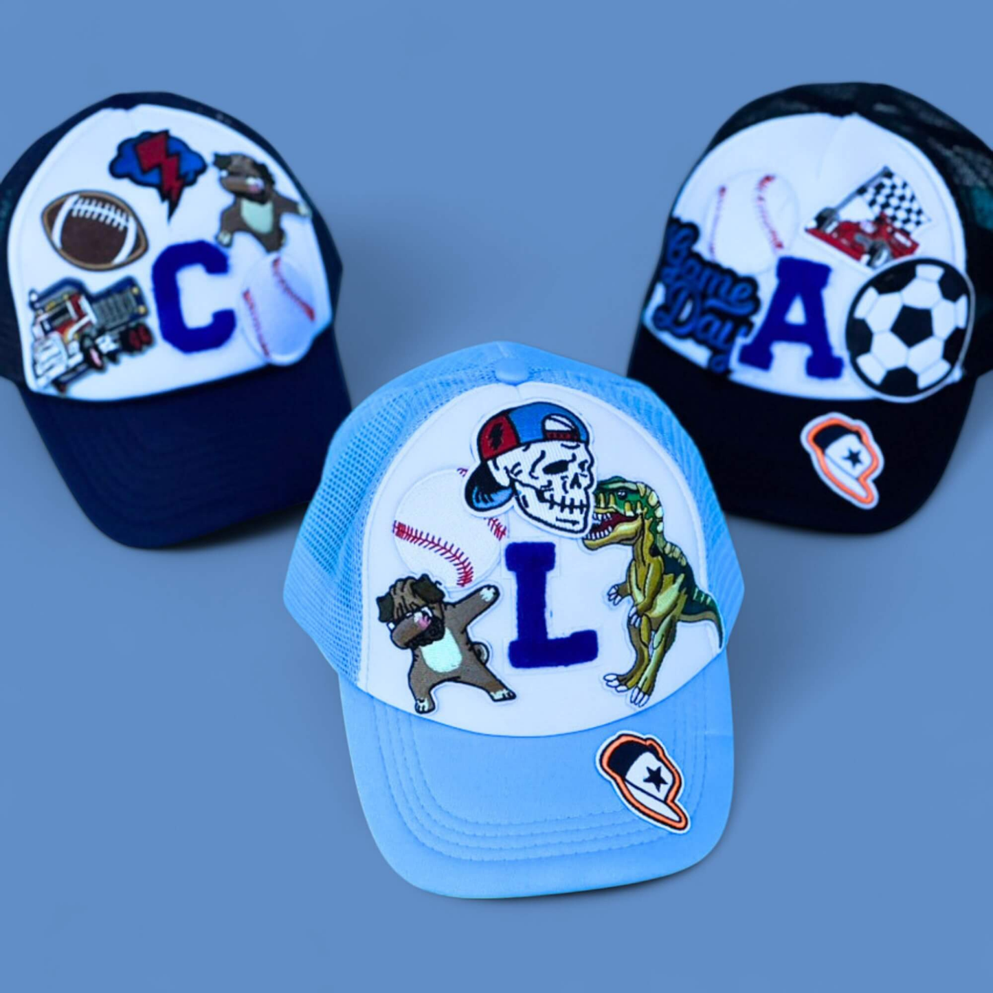 Three colorful caps with various designs on a blue background