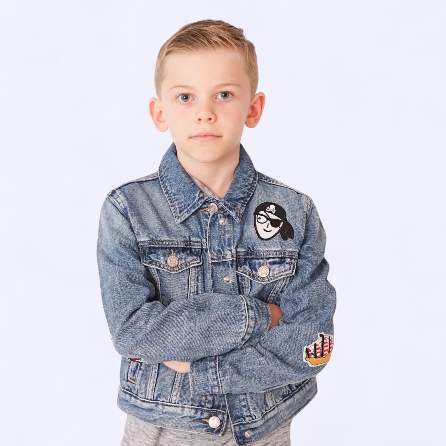 Custom denim jacket for boys with sewn chenille initial patch on front pocket